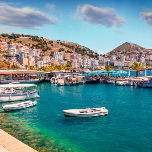 Perfect spring cityscape of Saranda port. Picturesque Ioninian seascape. Bright morning scene of Albania, Europe. Traveling concept background.