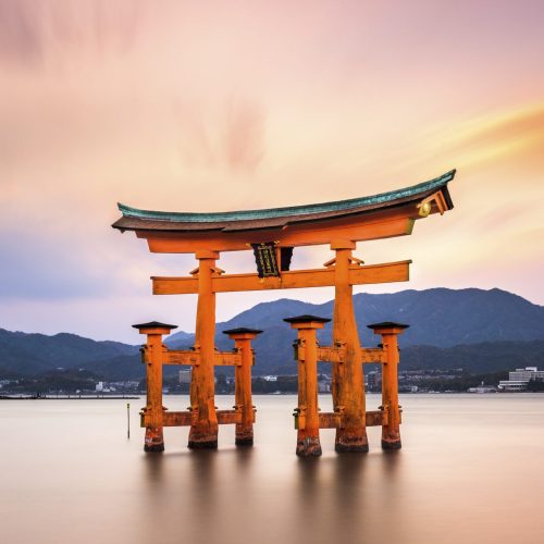 Miyajima, Hiroshima, Japan at the great gate of Itsukushima shrine. (gate sign reads Itsukushima Shrine)