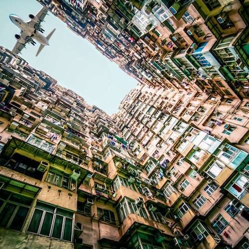 cityscape scenery of monster building in Hong Kong with airplane fly over