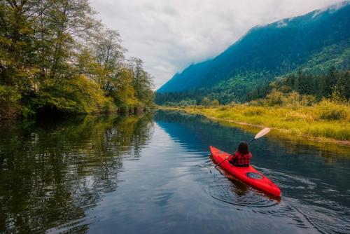 Adventure Caucasian Adult Woman Kayaking in Red Kayak